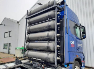 Photo of a semi tractor truck with the fuel tanks mounted on the back of the driver´s compartment.