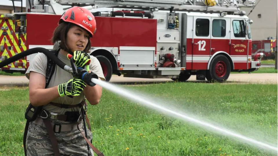 U.S. Air Force Academy Cadet 2nd Class Madison Tung sprays a fire hose during a fire training challenge at Kunsan Air Base, Republic of Korea, July 11, 2017. The visit was part of the Air Force Academy’s Operation Air Force program which allows cadets to travel different bases to learn about different careers and missions. (U.S. Air Force photo by Senior Airman Michael Hunsaker/Released)