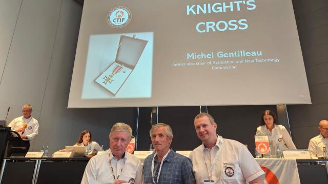 Michel Gentilleau (middle in photo) receives the Knight's Cross Award from CTIF. Left: Milan Dubravac, CTIF President. Right: Tom Van Esbroeck, CTIF Treasurer. 